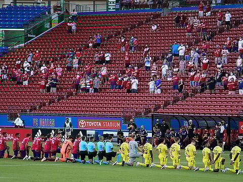Dallas and Nashville players are booed as they take a knee