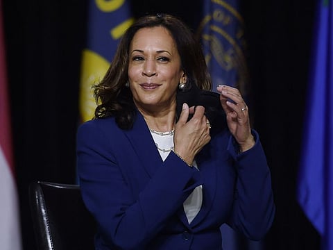 Democratic vice-presidential running mate, US Senator Kamala Harris removes her mask before speaking during the first press conference with Joe Biden in Wilmington, Delaware, on August 12, 2020.