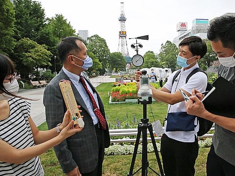 Yasuo Mori (2nd L), Deputy Executive Director of Tokyo 2020's Games Operations Bureau, and officials check the temperature and wind speed in the field verification of the Games Organizing Committee for holding the Tokyo Olympics Marathon and Racewalking in Sapporo on August 6.