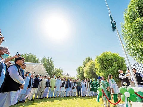 Ahmad Amjad Ali raising the Pakistani national flag during the Pakistani National Day Celebration at the Consul General of Pakistan in Bur Dubai.