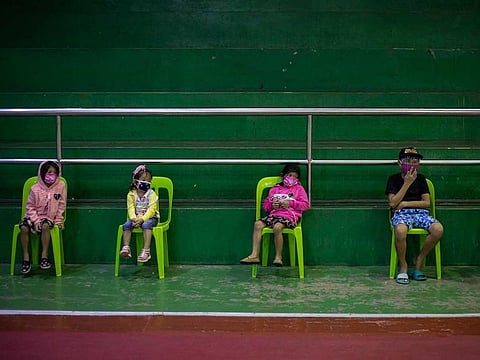 Children queue for a free COVID-19 swab testing at a gymnasium in Navotas City, Metro Manila.