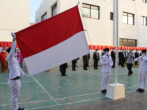 The Indonesian flag being hoisted at the country's embassy in Abu Dhabi on Monday on the occasion of its 75th Independence Day.