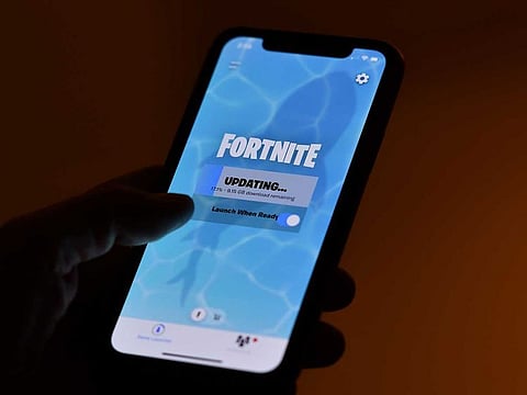 A person waiting for an update of Epic Games' Fortnite on their smartphone in Los Angeles.