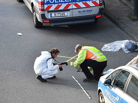 Investigators work on the scene following several accidents on the city motorway A100 in Berlin, Germany, Wednesday, Aug. 19, 2020. According to German news agency dpa, prosecutors say a series of crashes caused by a 30-year-old Iraqi man on the highway late Tuesday night was an extremist attack.