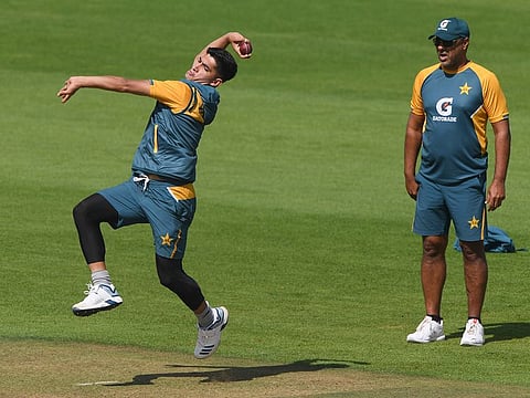 Pakistan's bowling coach Waqar Younis, right, watches Naseem Shah bowl to warm up, at the Ageas Bowl in Southampton.