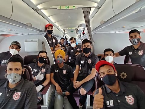 Kings XI Punjab players wear their masks on the flight to the UAE