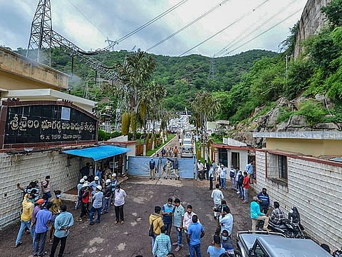 Police and locals gather outside Srisailam Left Bank Power Station (SLBP) after a fire broke out on Thursday night, at Srisailam in Kurnool district, Friday, Aug. 21, 2020