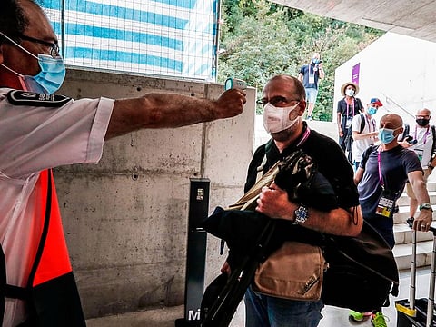 Journalists undergo a temperature scanning procedure upon their arrival for the UEFA Women's Champions League quarter-final football match between Arsenal and Paris SG at the Anoeta stadium in San Sebastian on August 22, 2020.