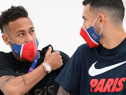 Paris St-Germain's Neymar and Leandro Paredes leave the team hotel in Lisbon on the way to training