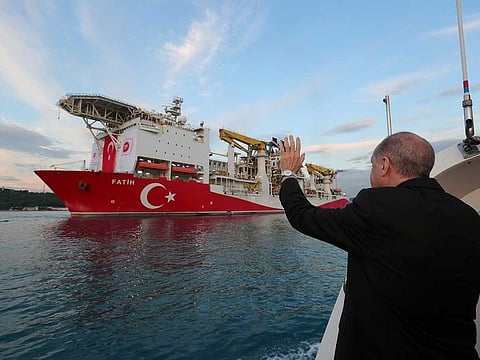 Turkish President Recep Tayyip Erdogan waves as Turkey's drilling vessel Fatih departs for the Black Sea