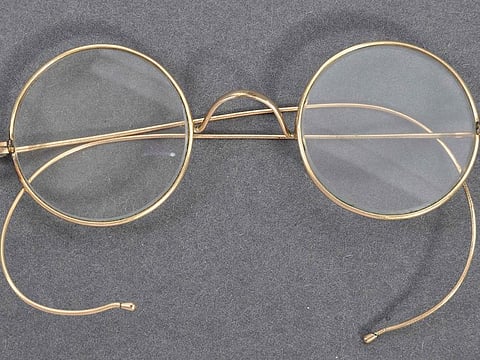 A handout picture released by East Bristol Auctions on August 19, 2020 shows a pair of glasses that once belonged to Indian independence icon Mohandas Karamchand Gandhi photographed at the action house in Bristol head of their sale.