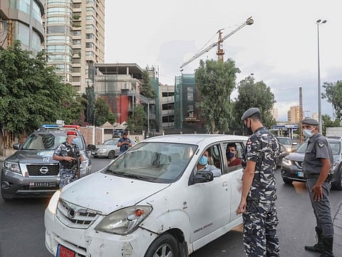 Members of the Lebanese security forces man a checkpoint on an avenue in the capital Beirut to verify the compliance with restrictions on the first day of a reinstated lockdown to combat a surge in COVID-19 cases, on August 21, 2020.