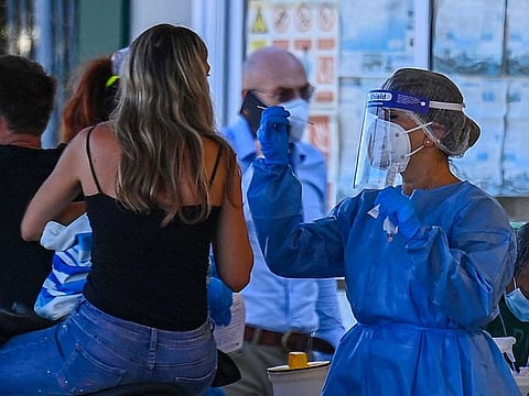 A holidaymaker on a motorbike returning from Sardinia by ferry undergoes a compulsory drive-through swab test on August 23, 2020 at the port of Civitavecchia, northwest of Rome, Italy, during the COVID-19 infection, caused by the novel coronavirus.