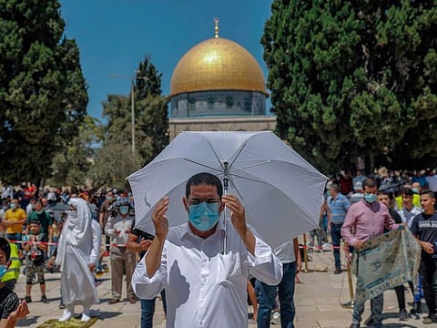 Palestinians perform the Friday prayer outside the Dome of the Rock Mosque, in Jerusalem's Al Haram Al Sharif mosques compound on August 21, 2020.