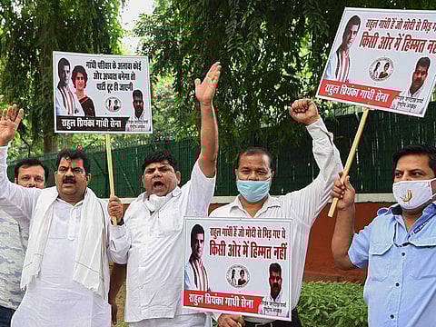 Supporters of India's Congress party hold placards and shout slogans as they demand that the party's president should be from the Gandhi family and leader Sonia Gandhi should continue as interim Congress president, outside the party headquarters in New Delhi on August 24, 2020.