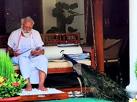 India's Prime Minister Narendra Modi engrossed in reading papers at his residence 7 Lok Kalyan Marg, in New Delhi on Sunday