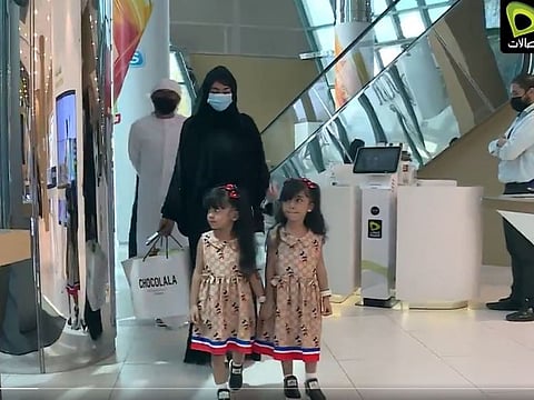 The little girl with her sister and parents inside the Etisalat building