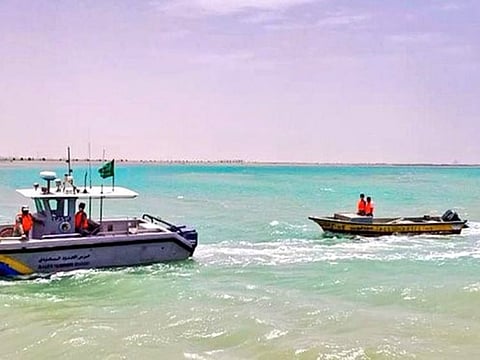 Saudi Border Guards tow the boat to safety.