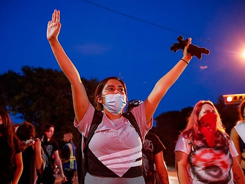A protester holds up her hands during a demonstration against the shooting of Jacob Blake in Kenosha, Wisconsin on August 26, 2020.