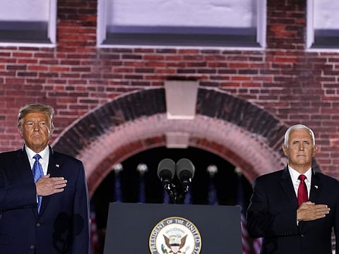 President Donald Trump and Vice President Mike Pence stand for the National Anthem on the third day of the Republican National Convention at Fort McHenry National Monument and Historic Shrine in Baltimore, Wednesday, Aug. 26, 2020