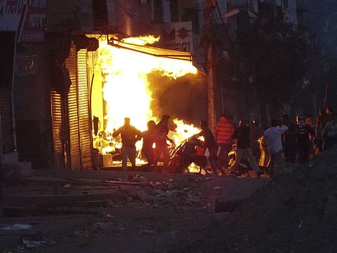 In this Tuesday, February 25 file photo, a shop burns after it was set on fire by a mob in New Delhi, India.