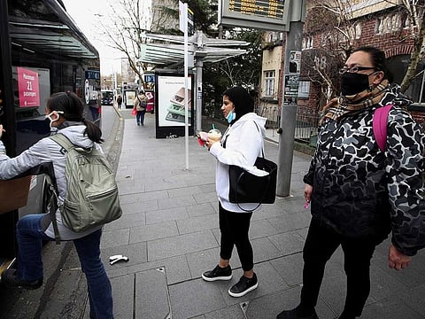 People wearing face masks prepare to board a bus on the first day of New Zealand's new coronavirus disease (COVID-19) safety measure that mandates wearing of a mask on public transport, in Auckland, New Zealand, August 31, 2020.