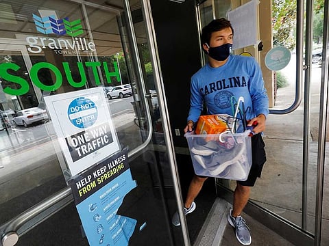 An undergraduate attending the University of North Carolina complies with a requirement for students to move out of campus housing due to the coronavirus disease (COVID-19) outbreak in Chapel Hill, North Carolina, U.S. August 30, 2020.