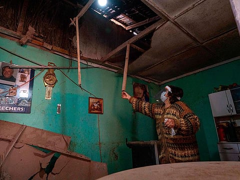 A woman shows the damaged roof of her house in Copiapo, northern Chile on September 1, 2020, after a 6.8-magnitude quake