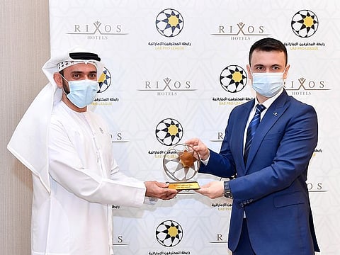 Waleed Al Hosani, UAE Pro League CEO (left) and Cenk Unverdi, Rixos Hotels' Regional General Manager, pose after signing the agreement.