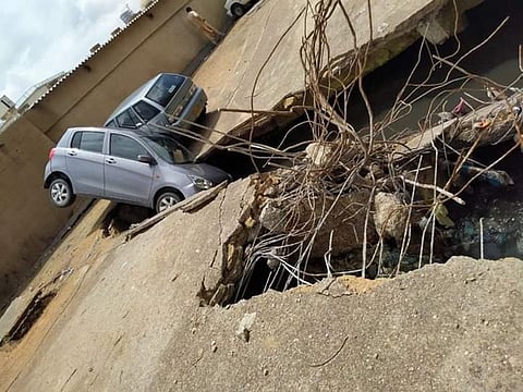 A parking lot next to a commercial building in downtown Karachi in ruins after the drainage system beneath it collapsed due to heavy rains.