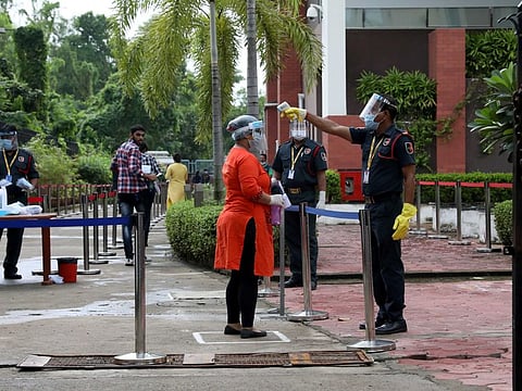 Covid precaution: A girl gets her temperature measured in Kolkata, India