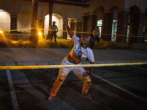 A protester dances in front deputies with the Los Angeles Sheriff's Department during protests following the death of Dijon Kizzee on Monday, Aug. 31, 2020, in Los Angeles, Calif