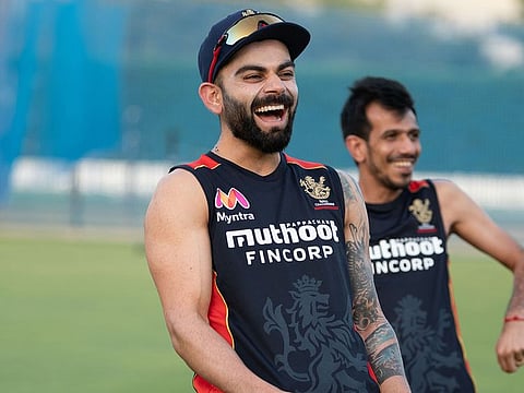 Royal Challengers Bangalore skipper Virat Kohli shares a laugh in training in Dubai.