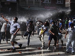 Nepal protesters defy virus lockdown, clash with riot police