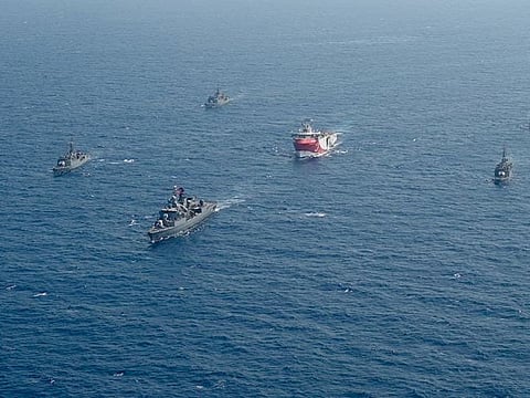 In this taken Monday, Aug. 10, 2020, Turkey's research vessel, Oruc Reis, centre, is surrounded by Turkish navy vessels as it was headed to Antalya in the Mediterranean