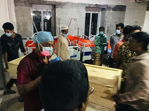 People carry out the coffin of a victim of a gas pipeline explosion, at a hospital in Dhaka.