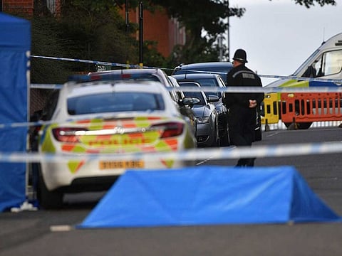 A police officer and vehicles are seen at a cordon in Irving Street in Birmingham after a number of people were stabbed in the city centre, Sunday, Sept. 6, 2020.