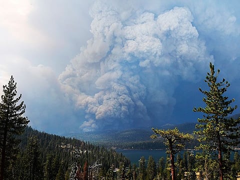 Plumes of smoke rise into the sky as a wildfire burns on the hills near Shaver Lake, Calif., Saturday, Sept. 5, 2020.