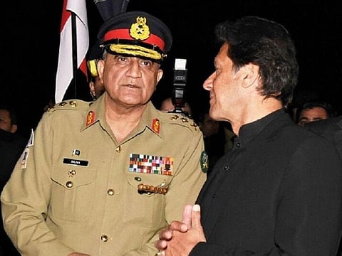 Pakistan's Prime Minister Imran Khan talks to the country's powerful army chief Qamar Javed Bajwa (File)