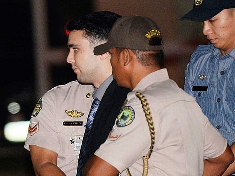 In this Dec. 1, 2015, file photo, convicted US Marine Lance Cpl. Joseph Scott Pemberton is escorted to his detention cell upon arrival at Camp Aguinaldo at suburban Quezon city, northeast of Manila, Philippines. The Philippine president pardoned the US Marine on Monday, Sept. 7, 2020 in a surprise move that will free him from imprisonment in the 2014 killing of a transgender Filipino woman that sparked anger in the former American colony.