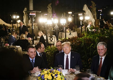 President Donald Trump, second from right, hosts President Jair Bolsonaro of Brazil, left, at a dinner at Mar-a-Lago in Palm Beach on March 7, 2020. At right is National Security Adviser Robert O'Brien.