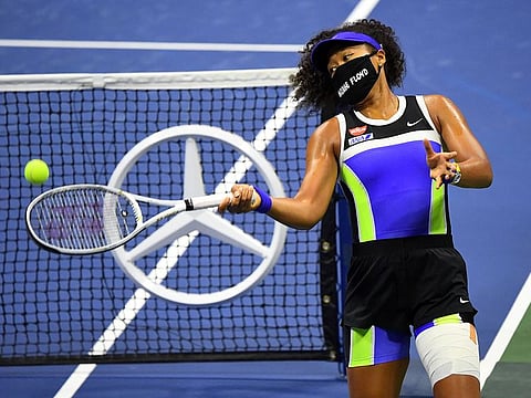 Naomi Osaka hits balls into the stands after her win against Shelby Rogers.