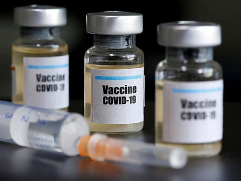 Small bottles labeled with a "Vaccine COVID-19" sticker and a medical syringe are seen in this illustration taken April 10, 2020.