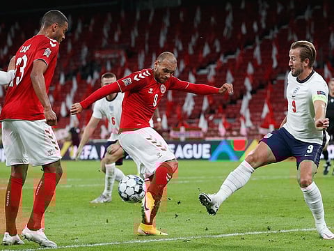 Denmark's Martin Braithwaite (in red) challenges England skipper Harry Kane during their goalless draw in Nations League on Tuesday.