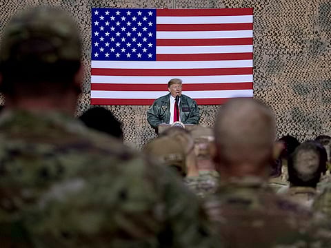 In this December 2018, file photo, President Donald Trump speaks to members of the military at a hangar rally at Al Asad Air Base, Iraq. Among veterans and military families across the United States, there are sharply mixed feelings about the new reports that Trump made multiple disparaging comments about the US military.