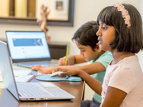 Students attend an e-learning session from home at their apartment in Al Nahda, Dubai.
