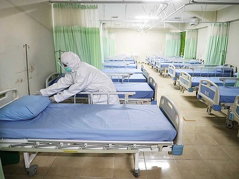 A medic inspects makeshift isolation rooms at Patriot Candrabhaga stadium prepared to become a quarantine facility for people showing symptoms of the COVID-19 amid the new coronavirus outbreak in Bekasi on the outskirts of Jakarta, Indonesia, Wednesday, Sept. 9, 2020.