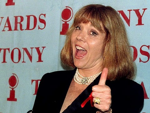 Diana Rigg gives the thumbs up sign as she holds her Tony Award for Best Performance by a Leading Actress in a Play in New York City, U.S., June 12, 1994.