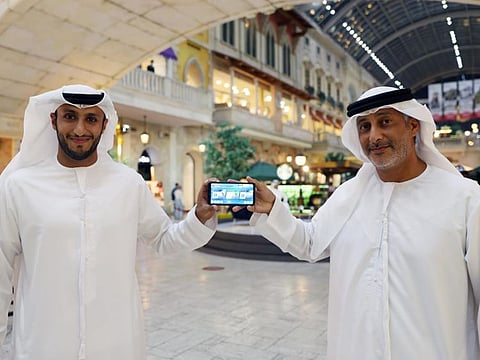 Mohammad Hareb, right, and Hezaim Al Gamzi launch the DIMC app