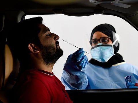 Paramedics taking swab sample at the SEHA drive through National Screening Center at Golf and Shooting club in Sharjah Photo: Virendra Saklani/Gulf News